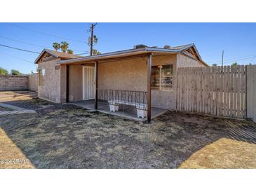 Cozy bungalow with covered porch and fenced yard at 2503 W Coolidge St, Phoenix, AZ 85017