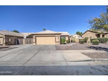 Single-story home with a two-car garage and well-maintained landscaping at 8146 W Hilton Ave, Phoenix, AZ 85043