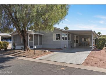 Cozy single-story home with covered carport and screened porch at 2550 S Ellsworth Rd # 215, Mesa, AZ 85209