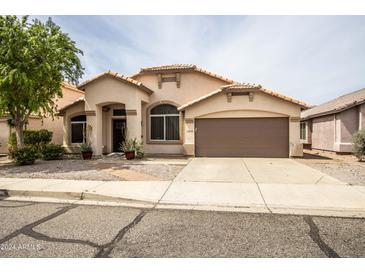 Tan one-story house with two car garage at 19824 N 14 Pln, Phoenix, AZ 85024