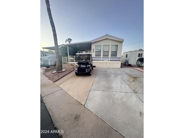 Mobile home exterior with carport and landscaping at 1541 W Yurok Ave, Apache Junction, AZ 85119