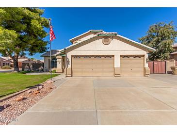 Two-story house with three-car garage and landscaped yard at 7752 W Mary Jane Ln, Peoria, AZ 85382