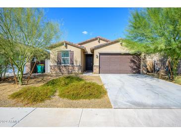 Modern single-story home with brown garage door at 12568 W Orangewood Ave, Glendale, AZ 85307