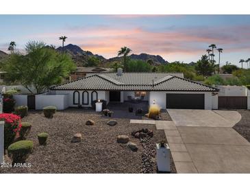 Single-story home with desert landscaping and mountain views at 3007 E Calaveros Dr, Phoenix, AZ 85028