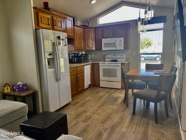 Bright kitchen with wood cabinets and dining area at 7750 E Broadway Rd # 761, Mesa, AZ 85208