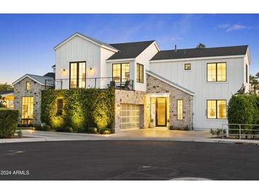 Stunning two-story farmhouse with stone and white siding at 4407 N 37Th Way, Phoenix, AZ 85018