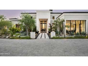Stunning curb appeal with a grand entrance, landscaped grounds, and paved driveway at 20958 N 112Th St, Scottsdale, AZ 85255