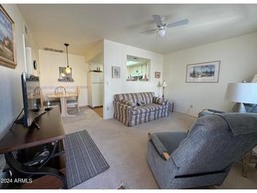 Spacious living room with open kitchen view and seating area at 3927 N Indiana Ave, Florence, AZ 85132