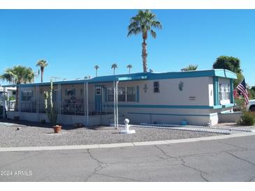 Mobile home with covered porch and desert landscaping at 201 S Greenfield Rd # 197, Mesa, AZ 85206