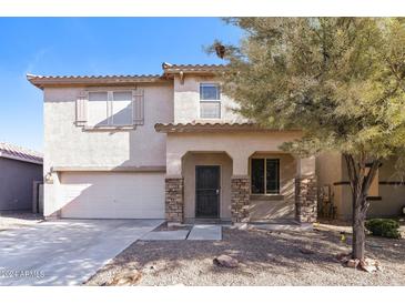 Two-story house with attached garage and landscaping at 42564 W Palmyra Ln, Maricopa, AZ 85138