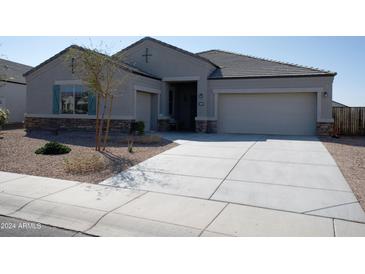 House exterior with a two-car garage and landscaped yard at 30893 W Pinchot W Ct, Buckeye, AZ 85396