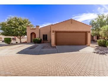 Single story home with two-car garage and desert landscaping at 3047 E Fremont Rd, Phoenix, AZ 85042