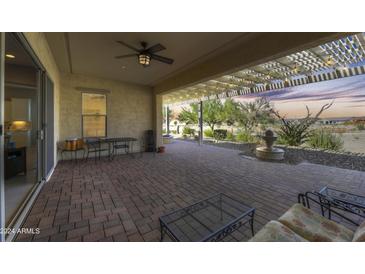Covered patio with brick flooring and fountain at 27552 W Tonopah Dr, Buckeye, AZ 85396
