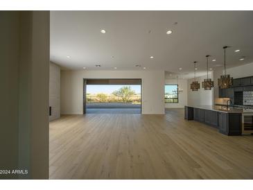 Open concept living space with hardwood floors and sliding doors to backyard at 13272 E La Junta Rd, Scottsdale, AZ 85255
