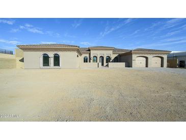 New construction home with beige facade and three-car garage at 13272 E La Junta Rd, Scottsdale, AZ 85255