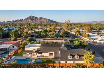 Aerial view of a remodeled mid-century modern home with pool and mountain views at 3014 N 61St Pl, Scottsdale, AZ 85251