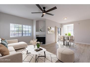 Open living room and dining area with modern decor and fireplace at 930 N Mesa Dr # 1039, Mesa, AZ 85201