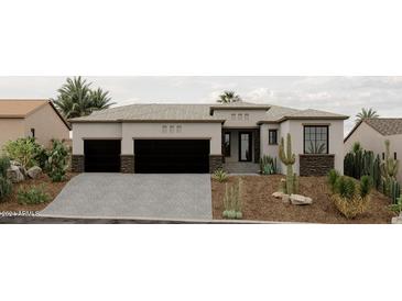 Stunning curb appeal with three-car garage and desert landscaping at 15522 E Chicory Dr, Fountain Hills, AZ 85268