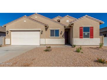 Tan two-story house with white garage door and red shutters at 7010 E Drygulch Rd, San Tan Valley, AZ 85143