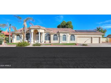 Beautiful tan house with tile roof, columns and 3 car garage at 1223 E Clearview Dr, Casa Grande, AZ 85122