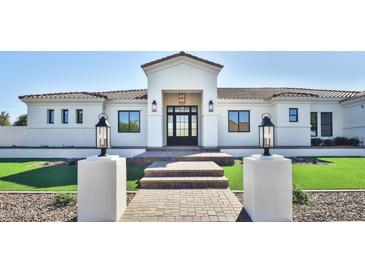 Stunning curb appeal, featuring a modern white exterior and landscaped lawn at 2041 N Orchard --, Mesa, AZ 85213