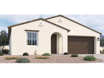 One-story home with brown garage door and desert landscaping at 37600 N Cowboy Ln, San Tan Valley, AZ 85140