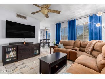 Relaxing living room with a sectional sofa and large TV at 1825 W Ray Rd # 1001, Chandler, AZ 85224