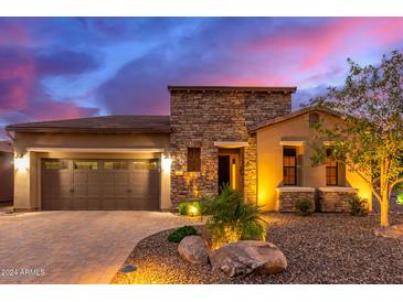 Single-story home with stone accents and desert landscaping at 28694 N 127Th Ln, Peoria, AZ 85383