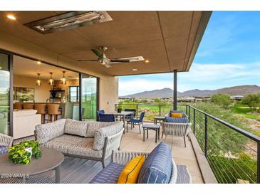 Covered patio with comfortable seating, mountain views, and golf course views at 37200 N Cave Creek Rd # 1082, Scottsdale, AZ 85262