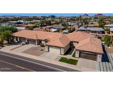 Three-unit property with individual garages and landscaped yards at 1712 N Miller Rd, Scottsdale, AZ 85257