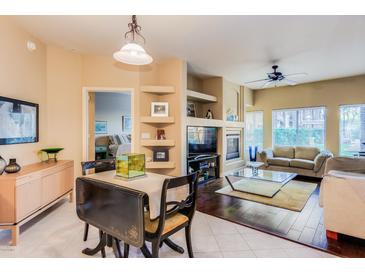 Open concept living and dining area with hardwood floors and fireplace at 5450 E Deer Valley Dr # 1209, Phoenix, AZ 85054