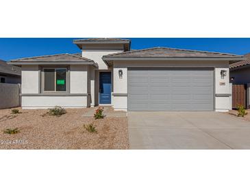 Newly constructed home with gray garage door and desert landscaping at 7400 E White Tail Rd, San Tan Valley, AZ 85143