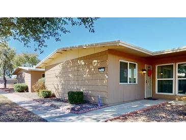 Tan single-story home with walkway and landscaping at 17447 N 99Th Dr, Sun City, AZ 85373