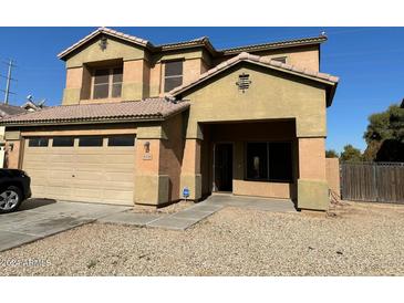 Two story home with large front yard and attached garage at 9406 W Elwood St, Tolleson, AZ 85353