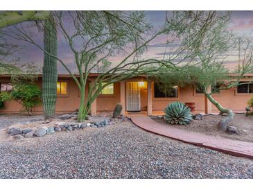 Single story home with brick walkway, desert landscaping, and warm-toned exterior at 985 W America St, Wickenburg, AZ 85390