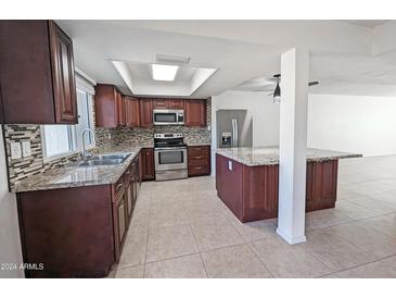 Kitchen with stainless steel appliances and granite countertops at 8214 E Mcdonald Dr, Scottsdale, AZ 85250