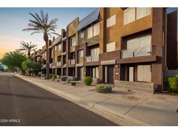 Modern building exterior with multiple units and street view at 6745 N 93Rd Ave # 1133, Glendale, AZ 85305