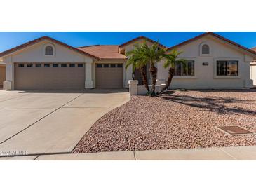 Single-story home with tan exterior and palm trees at 2222 S Yellow Wood --, Mesa, AZ 85209