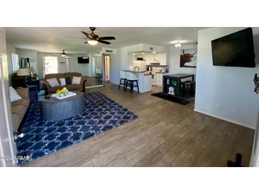 Open concept living room and kitchen with modern flooring at 14416 N Teakwood Ln # D, Fountain Hills, AZ 85268