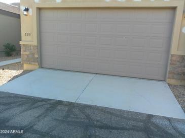 Attached two-car garage with concrete driveway at 846 N Pueblo Dr # 138, Casa Grande, AZ 85122