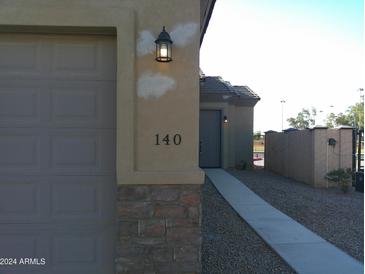 Modern home's exterior, showing a garage and walkway at 846 N Pueblo Dr # 140, Casa Grande, AZ 85122