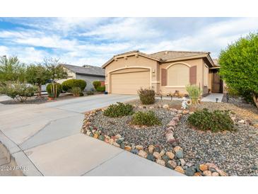 Tan house with two-car garage and landscaping at 7577 S Towel Creek Dr, Gold Canyon, AZ 85118