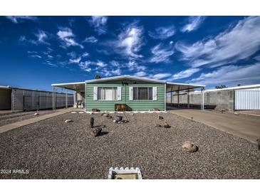 Mobile home with a well-maintained front yard and gravel landscaping at 260 S 72Nd Pl, Mesa, AZ 85208