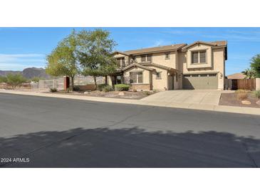 Two-story house with a three-car garage and landscaped front yard at 19428 W Colter St, Litchfield Park, AZ 85340