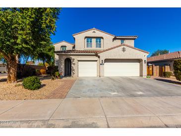 Two-story house with a three-car garage and landscaped front yard at 7788 W Lone Cactus Dr, Peoria, AZ 85382