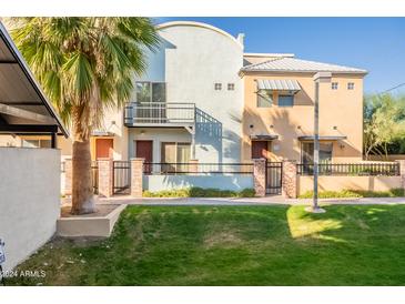 Two-story townhome with a private patio and grassy area at 1406 W Main St # 120, Mesa, AZ 85201