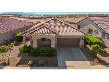 Single-story home with a two-car garage and landscaped front yard at 20403 W Calle Encorvada --, Buckeye, AZ 85396