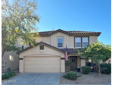 Two-story home with beige exterior and attached garage at 8953 E Yucca St, Scottsdale, AZ 85260