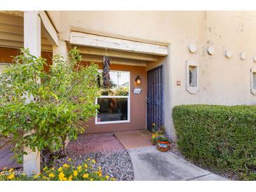 Front entrance with landscaping and wrought iron gate at 1425 E Desert Cove Ave # 49, Phoenix, AZ 85020