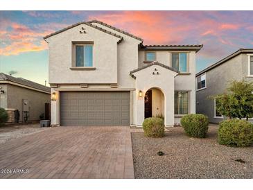 Two-story house with gray garage door and landscaping at 19834 W Rancho Dr, Litchfield Park, AZ 85340